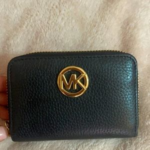 A black mini Michael Kors wallet